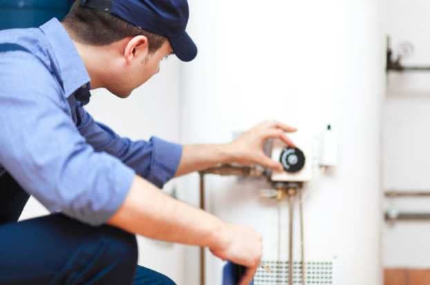 A plumber inspecting a water heater.